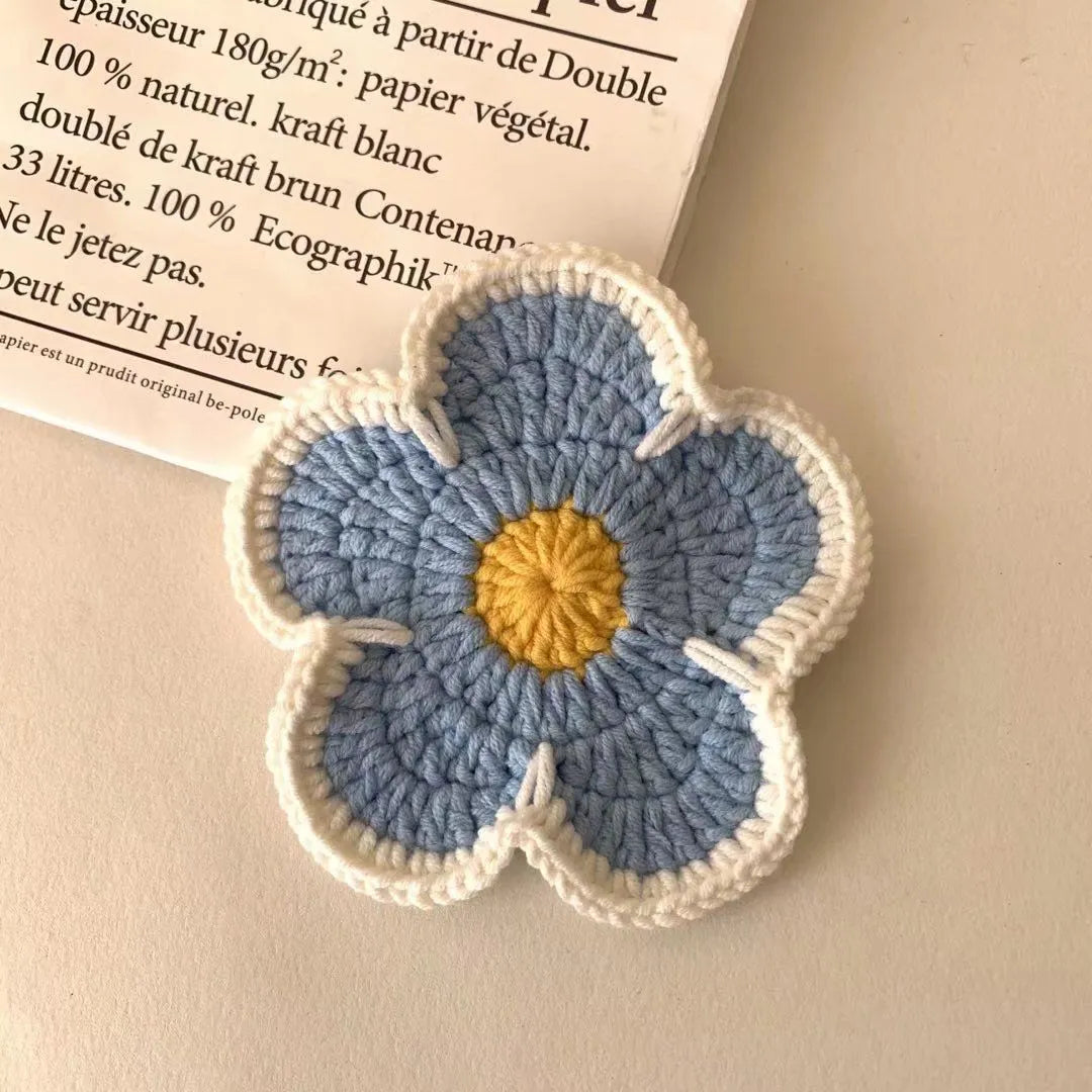 Colourful handmade cotton thread woven flower placemats on dining table