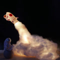 DIY astronaut rocket night light kit components including rocket model, LED lights, straws, and chassis on a desk.