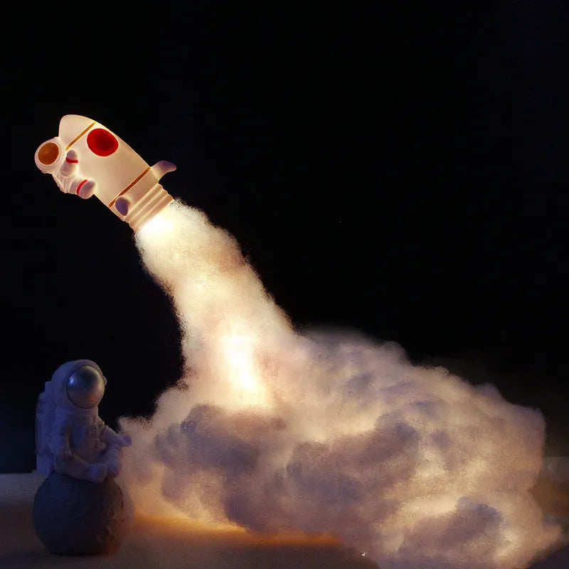 DIY astronaut rocket night light kit components including rocket model, LED lights, straws, and chassis on a desk.