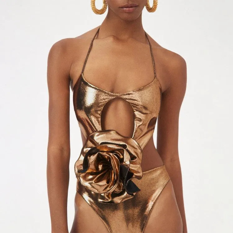 Gold handmade halter neck one-piece swimsuit with hollow-out detailing on a mannequin.