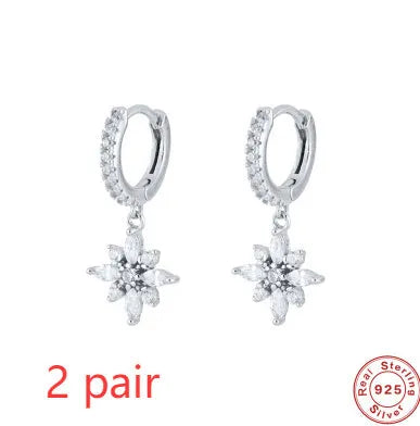 Pair of S925 sterling silver snowflake pendant earrings with gemstone inlay on a white background
