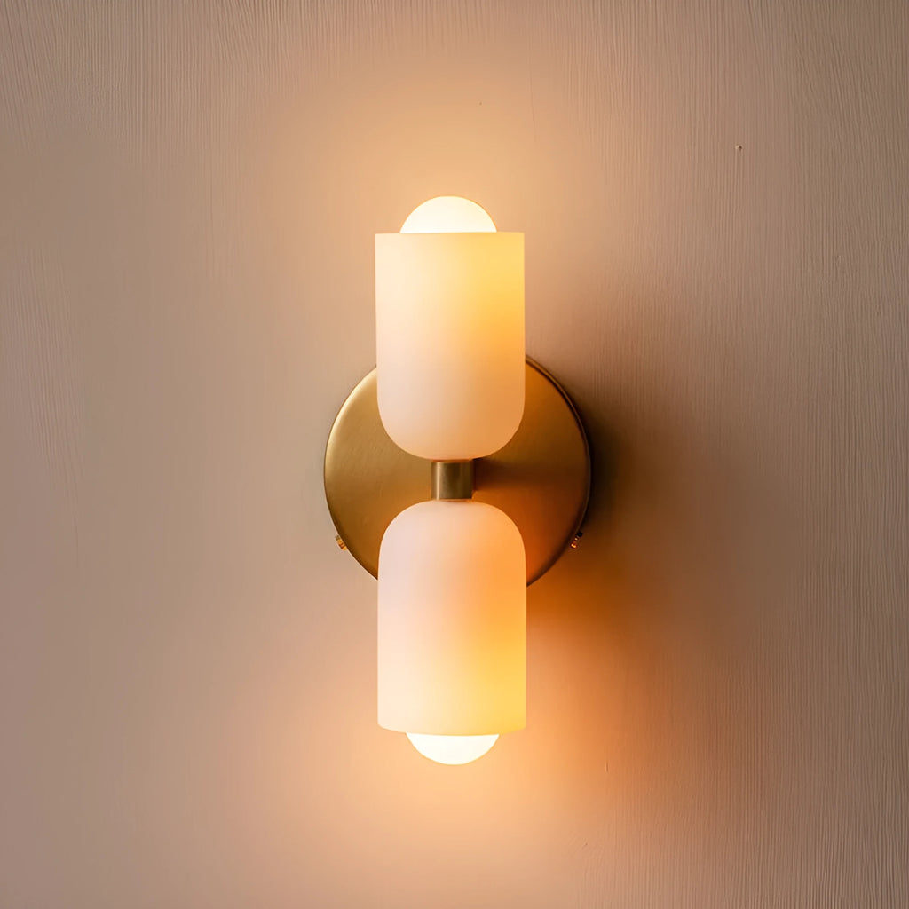 Cream base double head wall lamp with white glass shades against wall