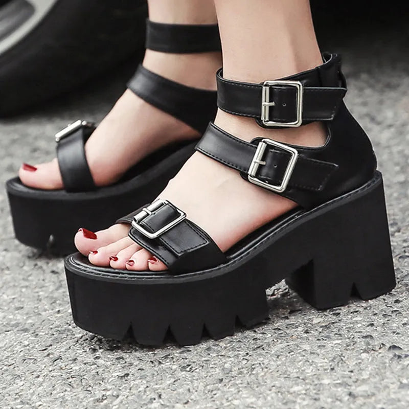 Black women's punk sandals with chunky thick heels, round toe, rear zipper, and a buckle detail.