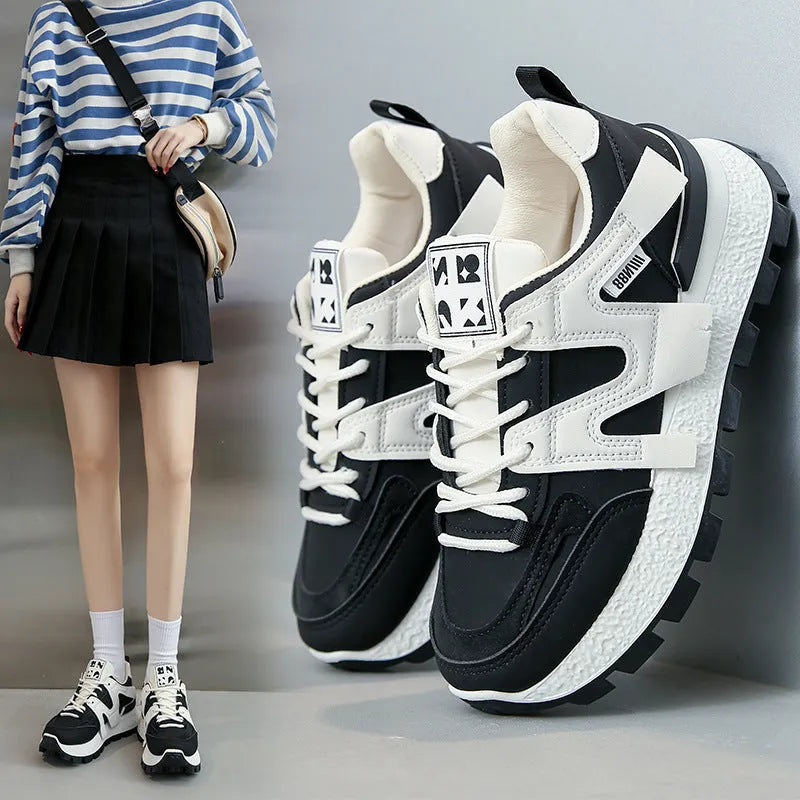 Women's low-top sneaker in black with artificial PU upper, rubber sole, and front lace-up closure.