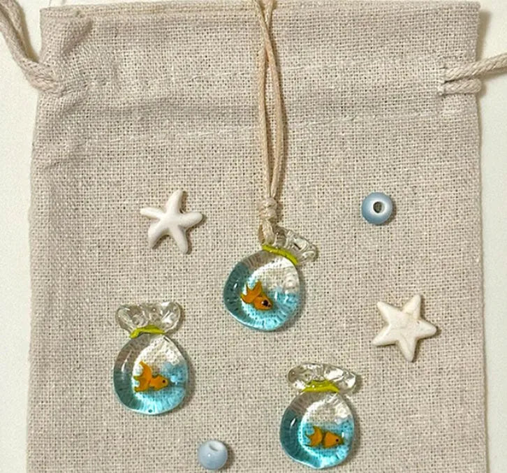 Women's necklace with coloured glaze skirt joker pendant on a beige cotton and linen chain, 45cm long.