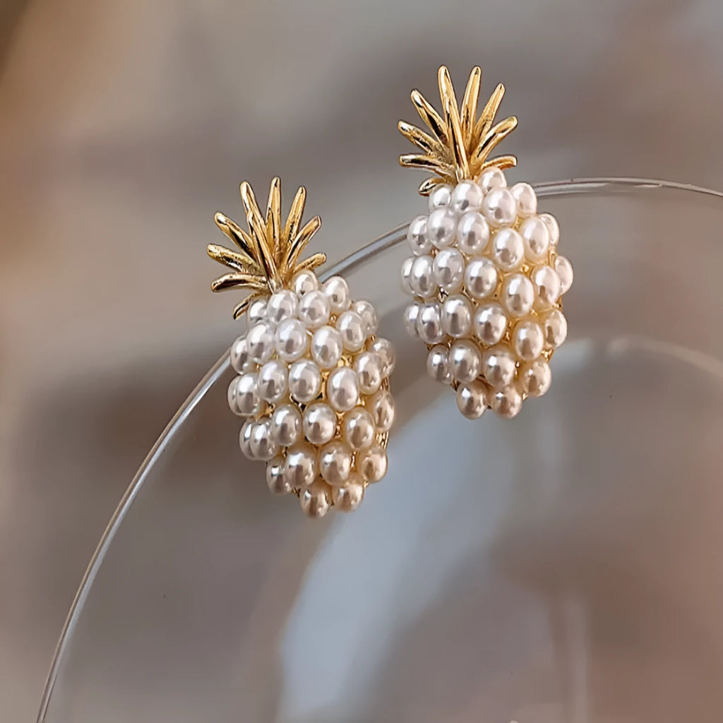Gold pineapple and starfish pearl Korean style drop earrings with alloy electroplating and inlaid gems.