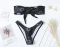 Black one-piece swimsuit with split tube top and backless design for swimming
