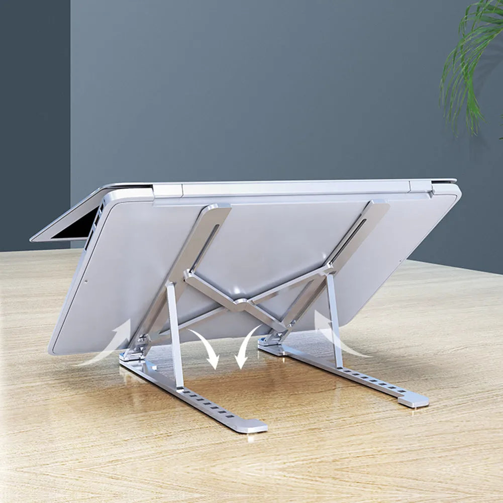 Silver aluminium folding laptop stand adjusted to medium height with a laptop in place.