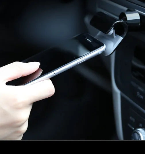 Black universal car phone holder with 360-degree rotation on car dashboard