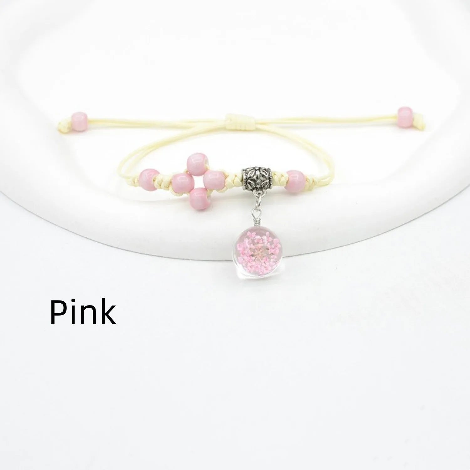 Hand-woven glass bracelet with large beads containing real dried flowers, shown in multiple colour options.