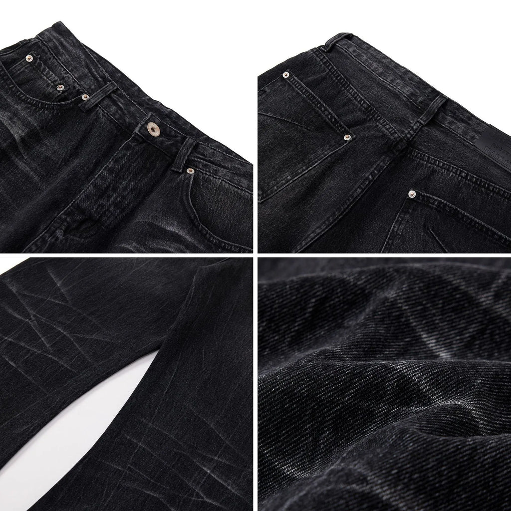Men's black American washed straight leg jeans with old lightning crack detailing on a plain background
