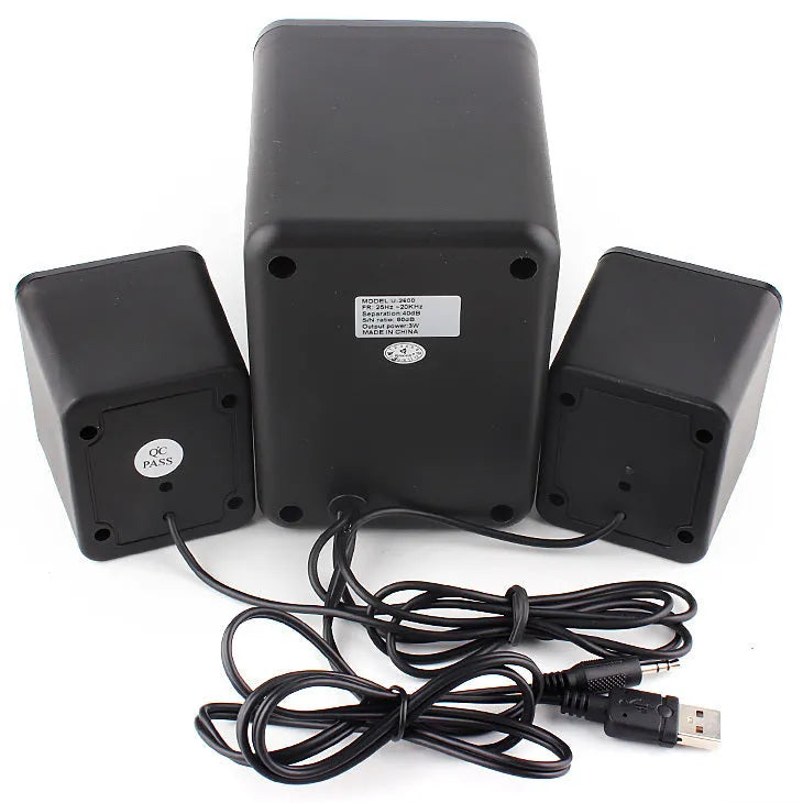 Green U-2600 mini 2.1 USB computer speaker with glowing colourful lights on a desk.