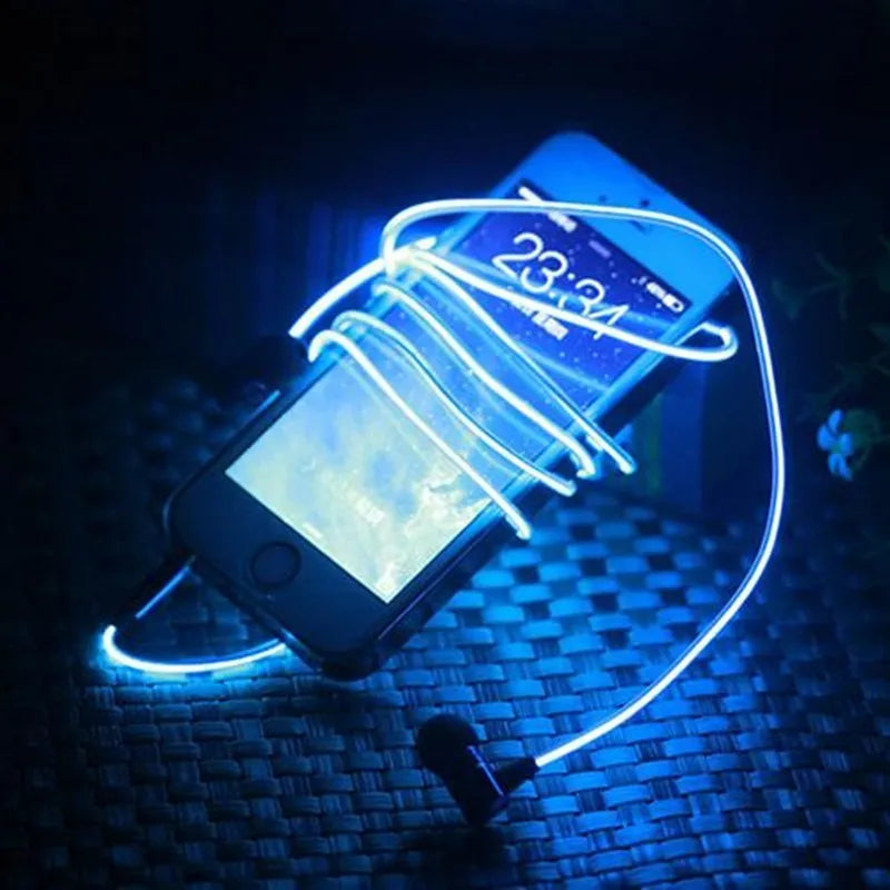 Blue, green, and pink LED earphones with glowing cables next to a smartphone, showcasing their music-reactive light feature.