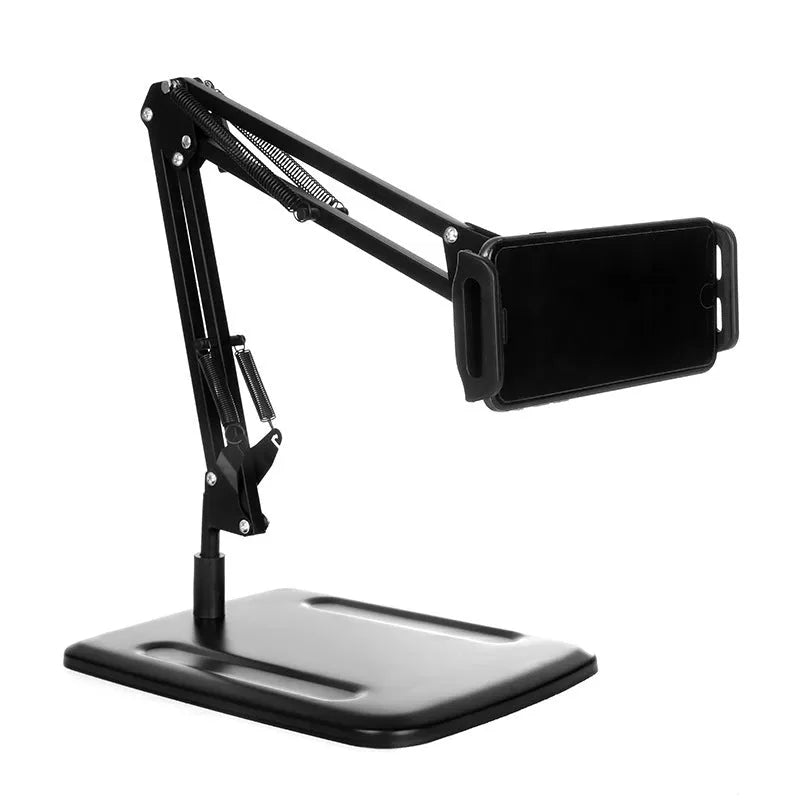 Black universal phone stand with long adjustable metal arm and heavy round base on a desk