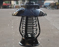 White and black solar-powered outdoor mosquito lamp with solar panel on top and LED light body.
