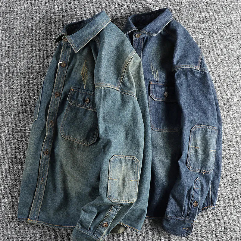 Man wearing a light blue vintage washed denim shirt with a loose fit and long sleeves.