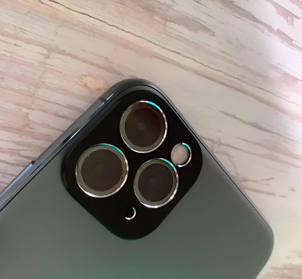 Metal phone grip ring in various colours attached to the back of an iPhone 11 Pro.