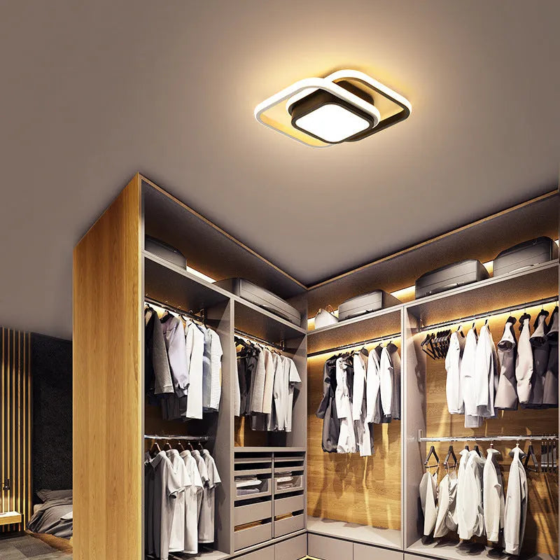 Modern round aluminium ceiling light with integrated LEDs, shown illuminating an entrance hall.