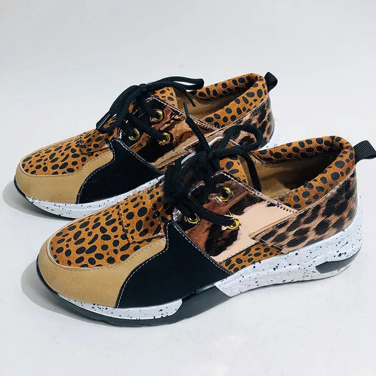 Women's casual suede wedge sneakers in leopard print with a low-cut design and plastic sole.