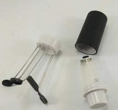 White and black automatic kitchen food stirrer with stainless steel whisk on countertop.