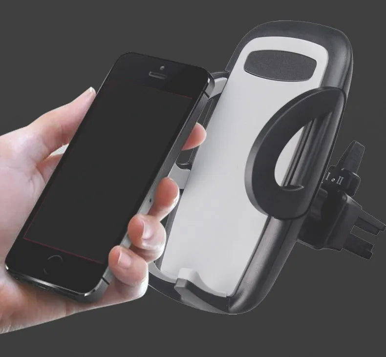 Black plastic car air vent phone holder attached to vehicle air conditioning outlet with mobile phone secured