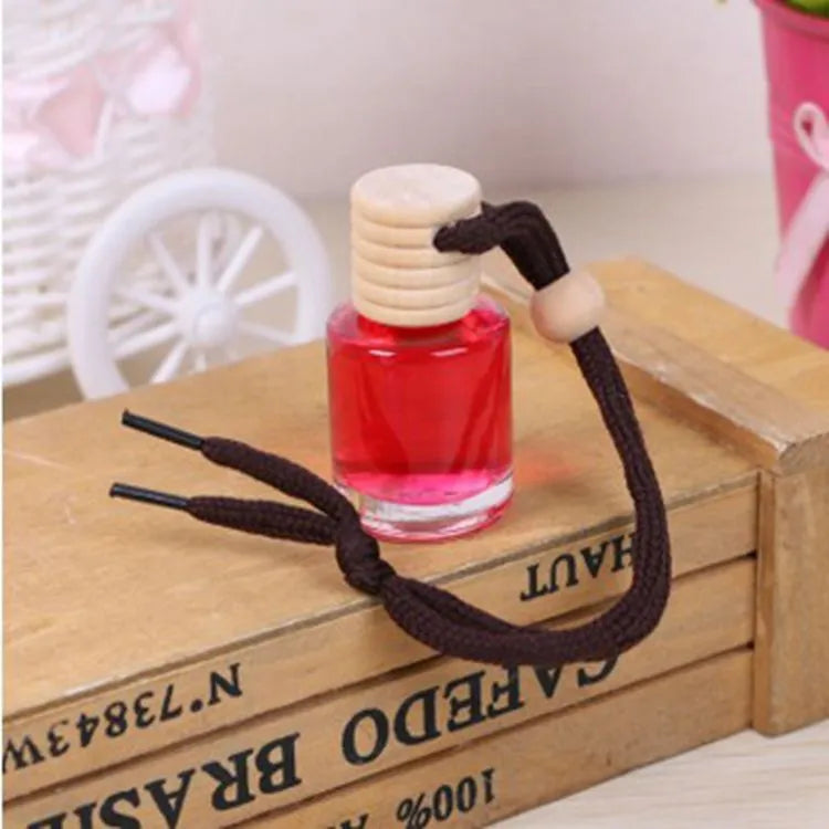 Glass bottle car air freshener hanging ornament with six fragrance refill options displayed