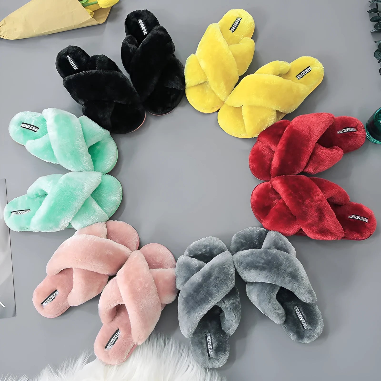 Cross open-toe fur slippers in black with a patterned non-slip rubber sole.