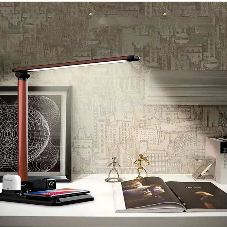 Black and white 4-in-1 LED desk lamp with wireless charging pad, Bluetooth speaker, and digital clock display.