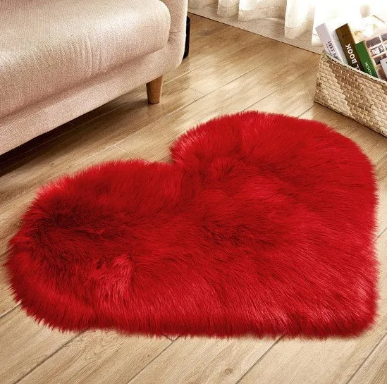 Heart-shaped plush carpet in multiple colours showing wool-like texture with 5-6 cm pile length
