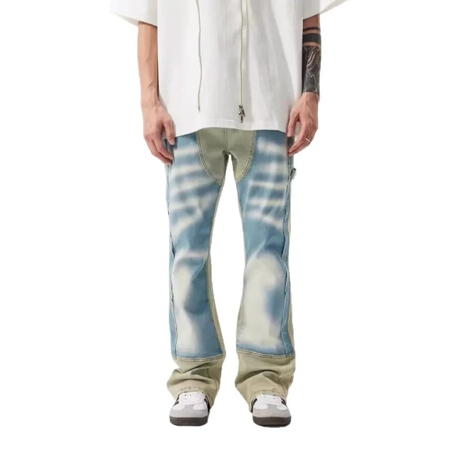 Yellow and blue retro patchwork jeans with splash-ink distressed design and zip fly.