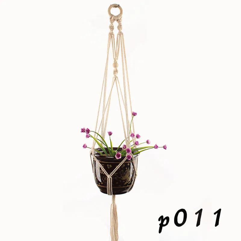 A rustic-style woven cotton rope plant trellis panel supporting green leaves.