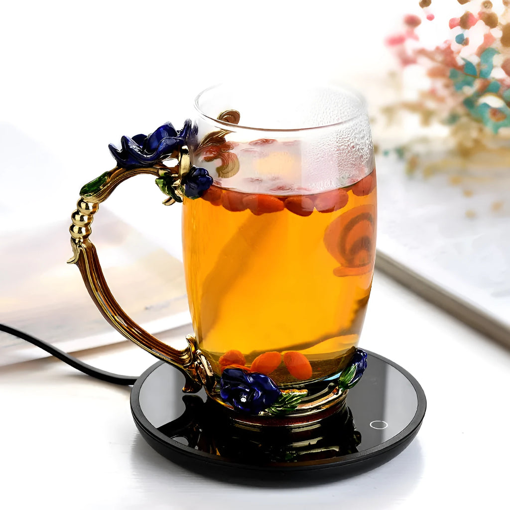Black round desk cup warmer with tempered glass surface and low high switch on a wooden table.