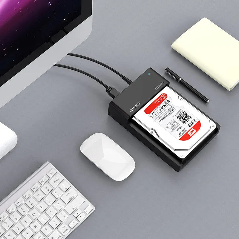 Black universal 2.5-inch and 3.5-inch SATA hard disk enclosure box with data cable.