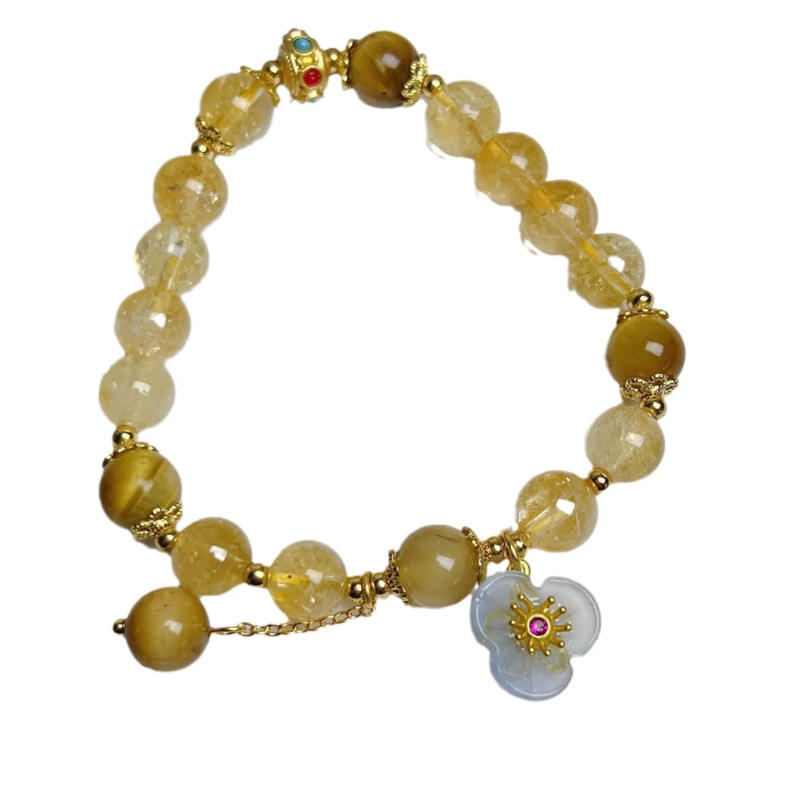 Close-up of a handcrafted citrine crystal bracelet for women with a floral tassel pendant.