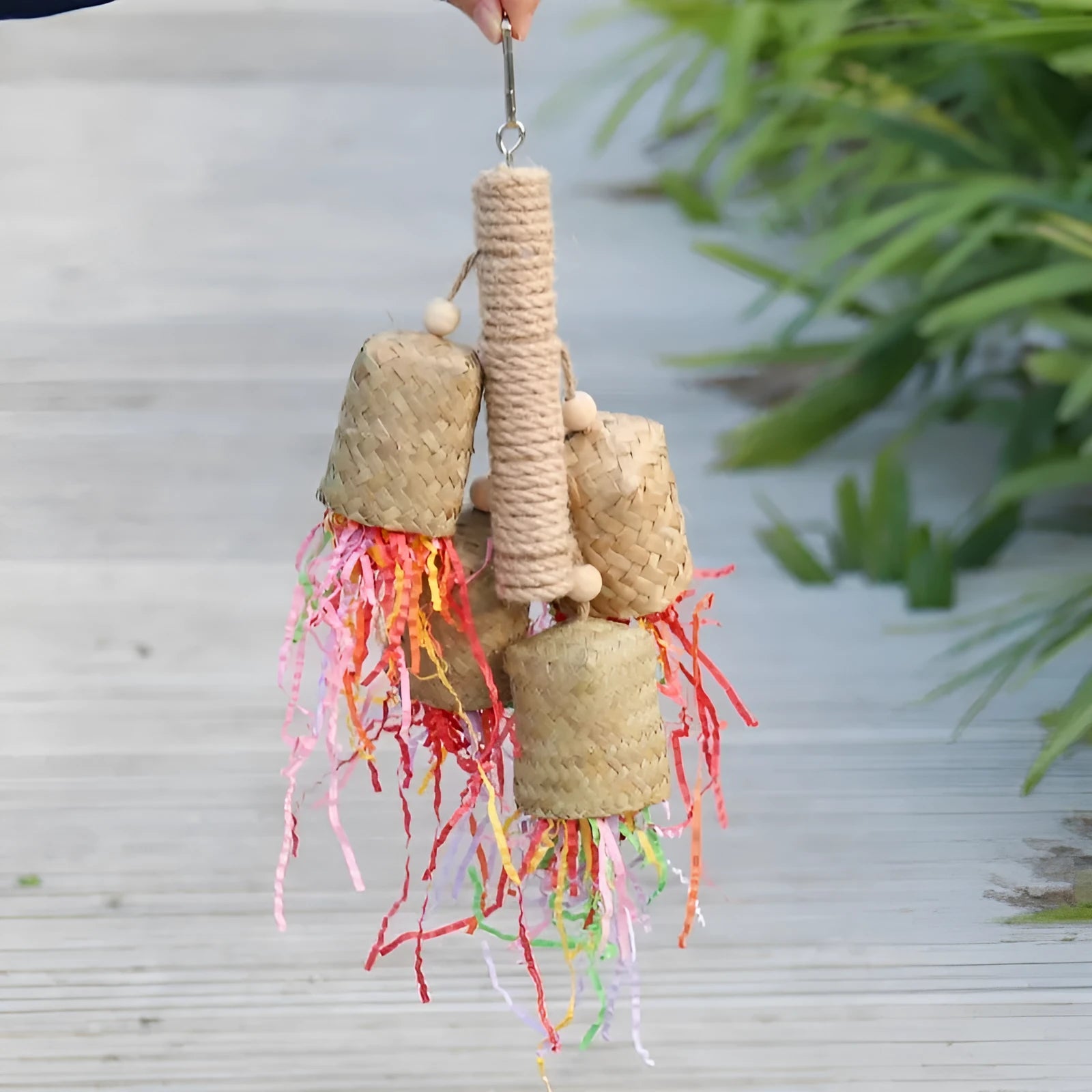 Parrot foraging toy made of wood and sisal rope with colourful shredded paper inserts
