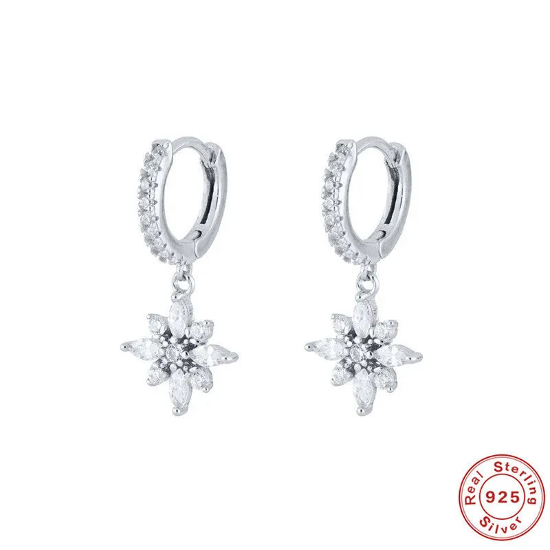 Pair of S925 sterling silver snowflake pendant earrings with gemstone inlay on a white background