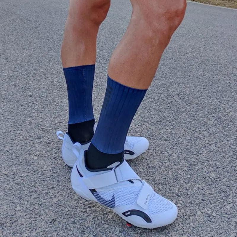 A pair of athletic cycling socks in a chemical fibre blend, shown in one of six available colours on a plain background.