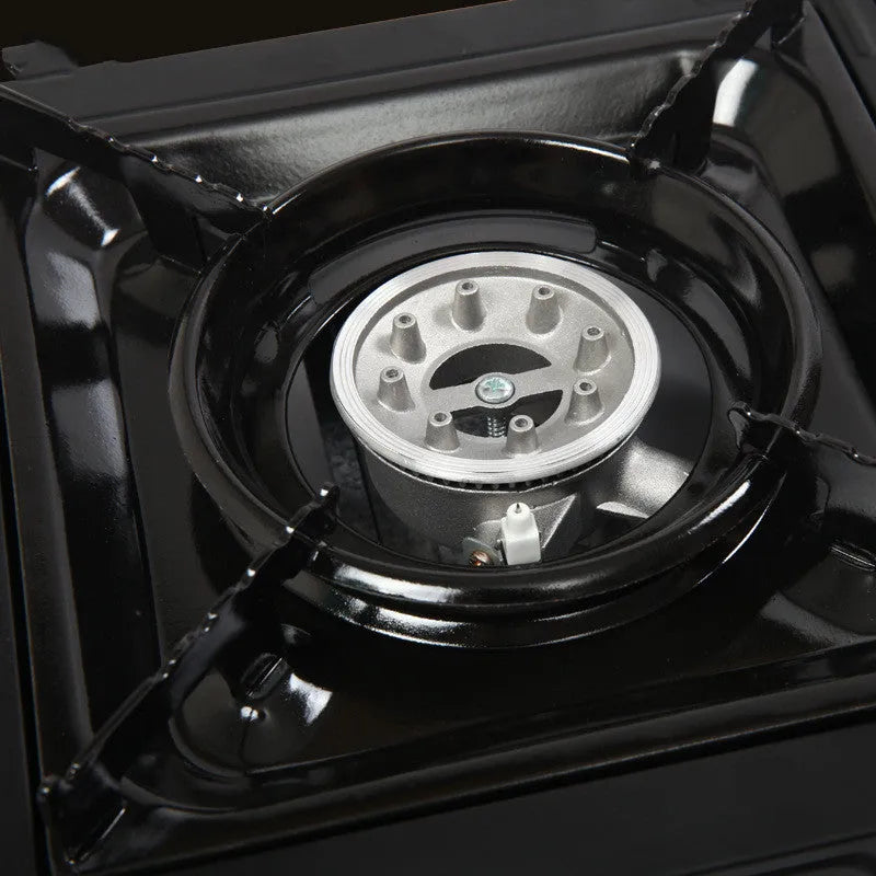 Black portable cassette stove with electronic ignition, 340x280x115mm, shown with black plastic box for camping and BBQ use