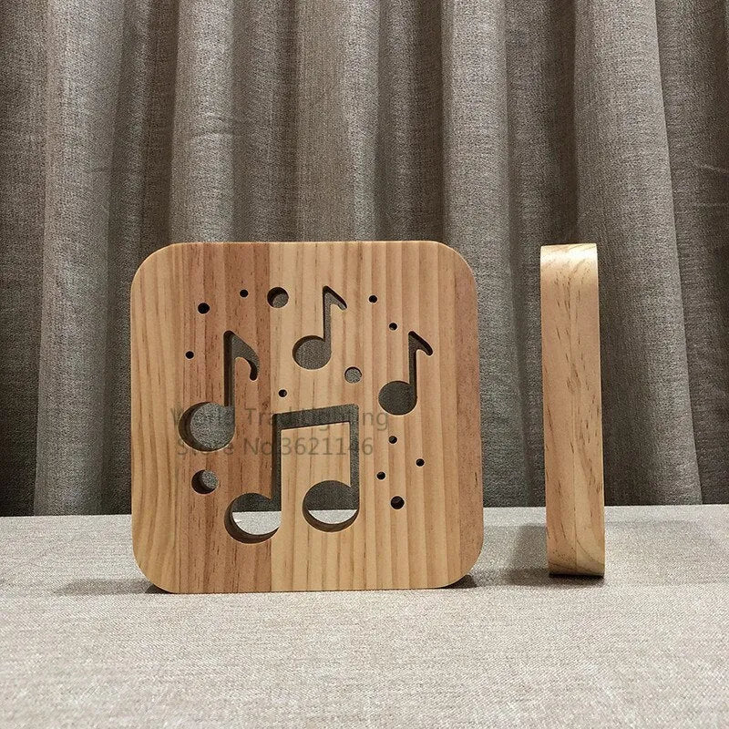 Square 3D wooden lattice USB lamp emitting warm white light on a desk, showing pine grain and USB cable.