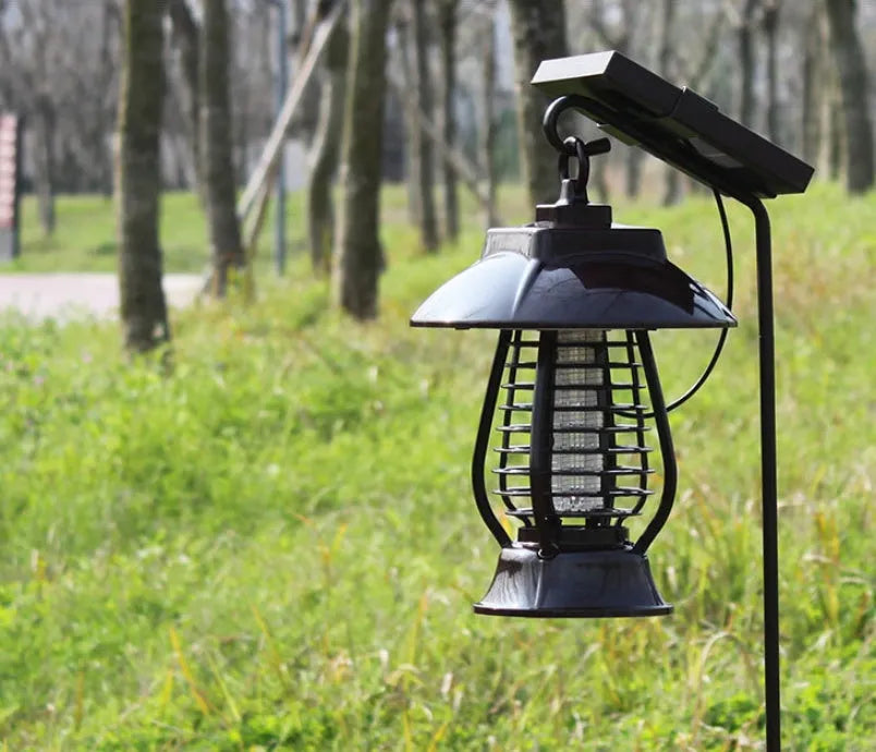 White and black solar-powered outdoor mosquito lamp with solar panel on top and LED light body.
