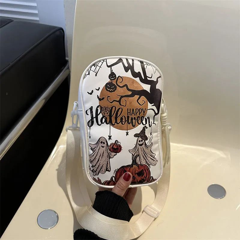 Black mini square crossbody bag with orange Halloween graffiti print of cartoon pumpkin, ghost, and bat.