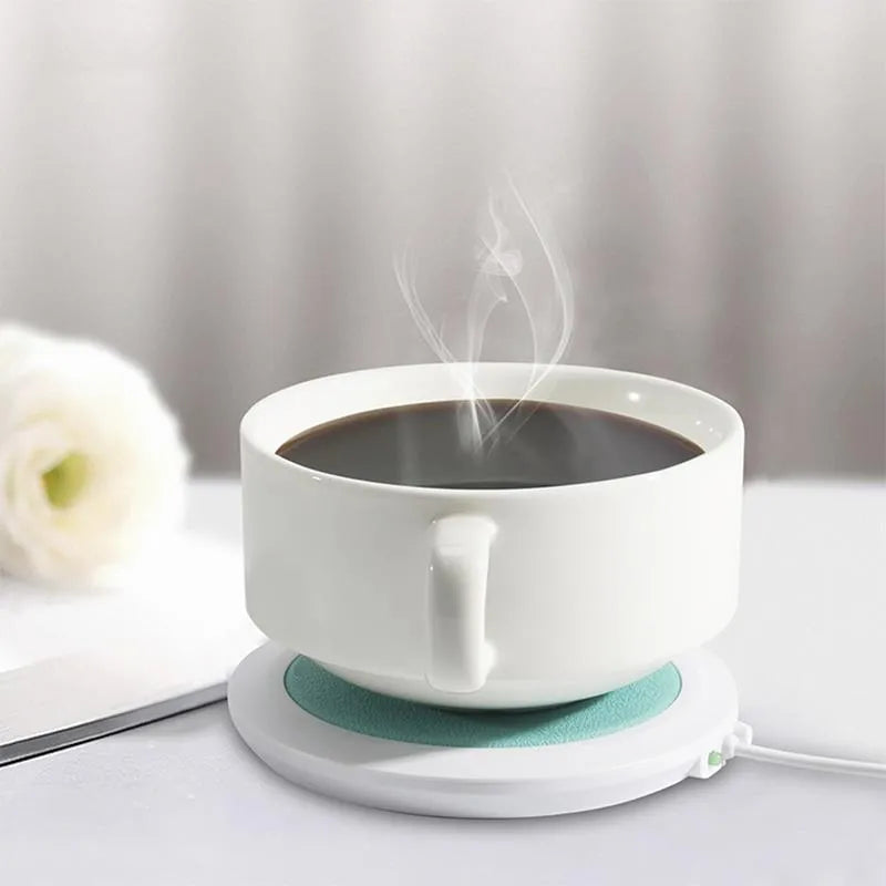 USB-powered insulated heating coaster in black, blue, and orange colours on a desk.