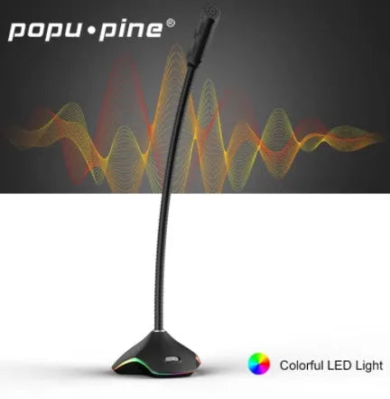 Black wired computer microphone with 3.5mm jack, blow-out sponge, and stand on a desk.