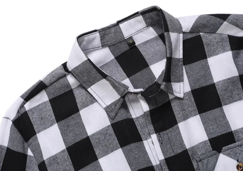 Men's long-sleeved black and white checked shirt with lapel collar and double chest pockets, front view.