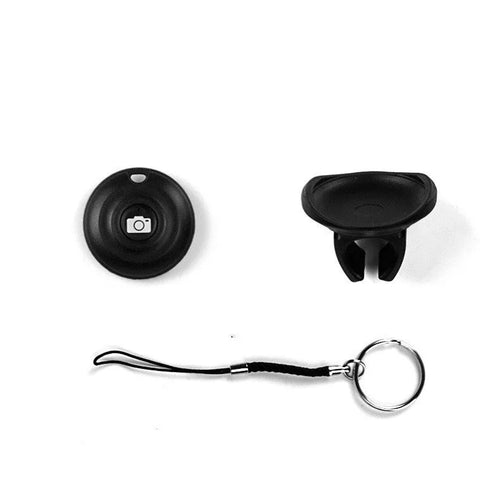 Black Bluetooth remote control for selfies with a single snap button on a white background.