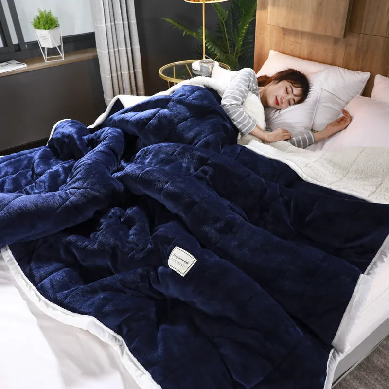 Thick coral fleece winter blanket in a solid colour, shown on a bed, dimensions 150cm by 200cm.