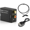 Black digital to analogue audio converter with optical cable and power supply