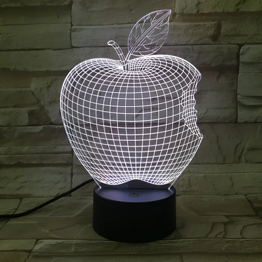 3D fruit-shaped colourful acrylic night light with touch control on a dark surface.