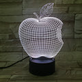 3D fruit-shaped colourful acrylic night light with touch control on a dark surface.
