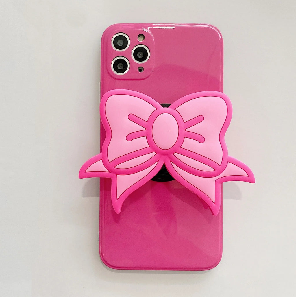 Rose red iPhone case with a large pink bow and a folded-out kickstand on the back.